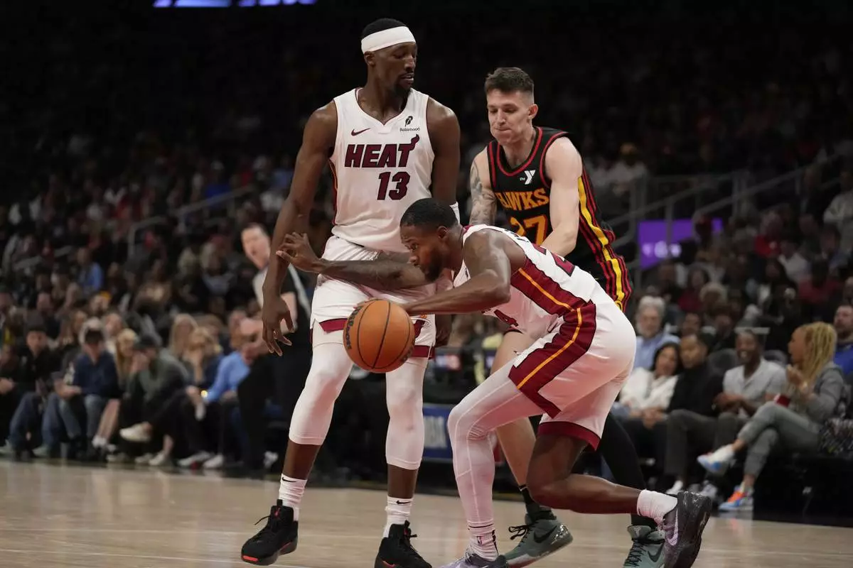 Miami Heat forward Haywood Highsmith (24) dribbles the ball in the first half of an NBA play-in tournament basketball game against the Atlanta Hawks Friday, April 18, 2025, in Atlanta. (AP Photo/Brynn Anderson)