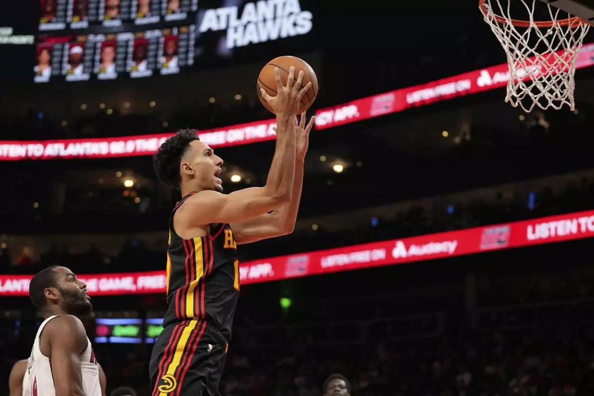 Atlanta Hawks forward Zaccharie Risacher (10) shoots the ball in the first half of an NBA play-in tournament basketball game against the Miami Heat, Friday, April 18, 2025, in Atlanta. (AP Photo/Brynn Anderson)