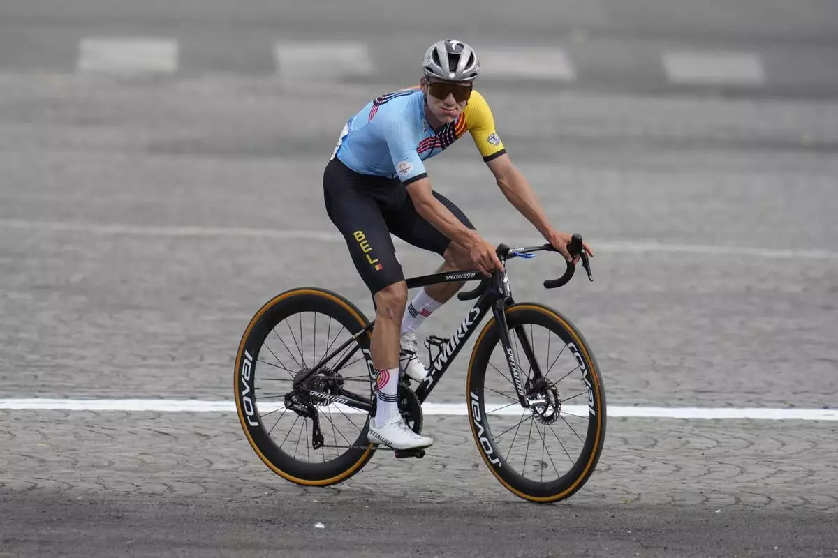 FILE -Remco Evenepoel, of Belgium, celebrates winning the men's road cycling event, at the 2024 Summer Olympics, Saturday, Aug. 3, 2024, in Paris, France. (AP Photo/Dar Yasin, File)