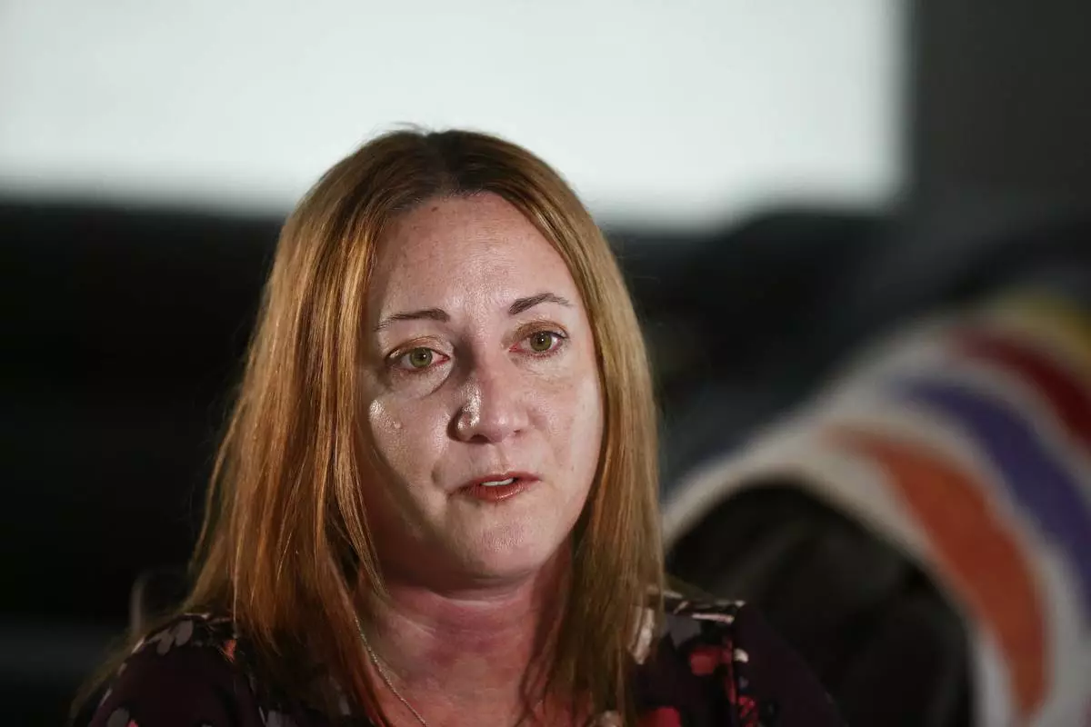 FILE - Lori Alhadeff, mother of 14-year-old Alyssa Alhadeff who was one of 17 people killed by a gunman who stalked the halls of Marjory Stoneman Douglas High School, cries while talking about her daughter on Wednesday, Jan. 30, 2019, in Parkland, Fla. (AP Photo/Brynn Anderson, File)
