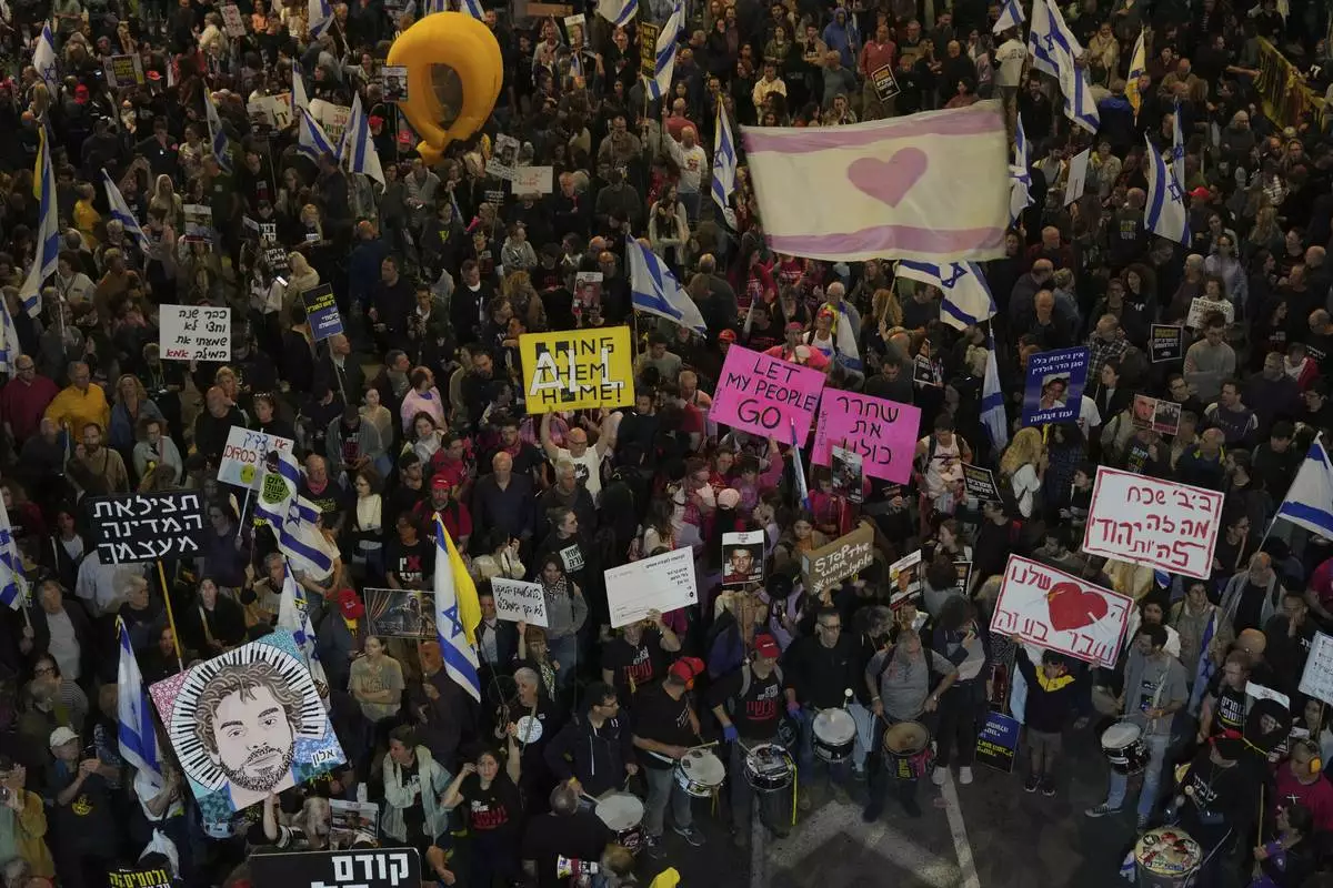 People take part in a protest demanding the immediate release of hostages held by Hamas in the Gaza Strip, in Tel Aviv, Israel, Saturday, April 5,2025. (AP Photo/Ariel Schalit)