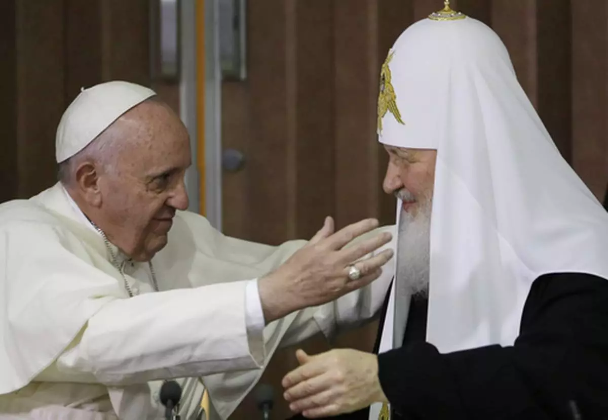 FILE - Pope Francis, left, reaches to embrace Russian Orthodox Patriarch Kirill after signing a joint declaration at the Jose Marti International airport in Havana, Cuba, Friday, Feb. 12, 2016. (AP Photo/Gregorio Borgia, Pool, File)
