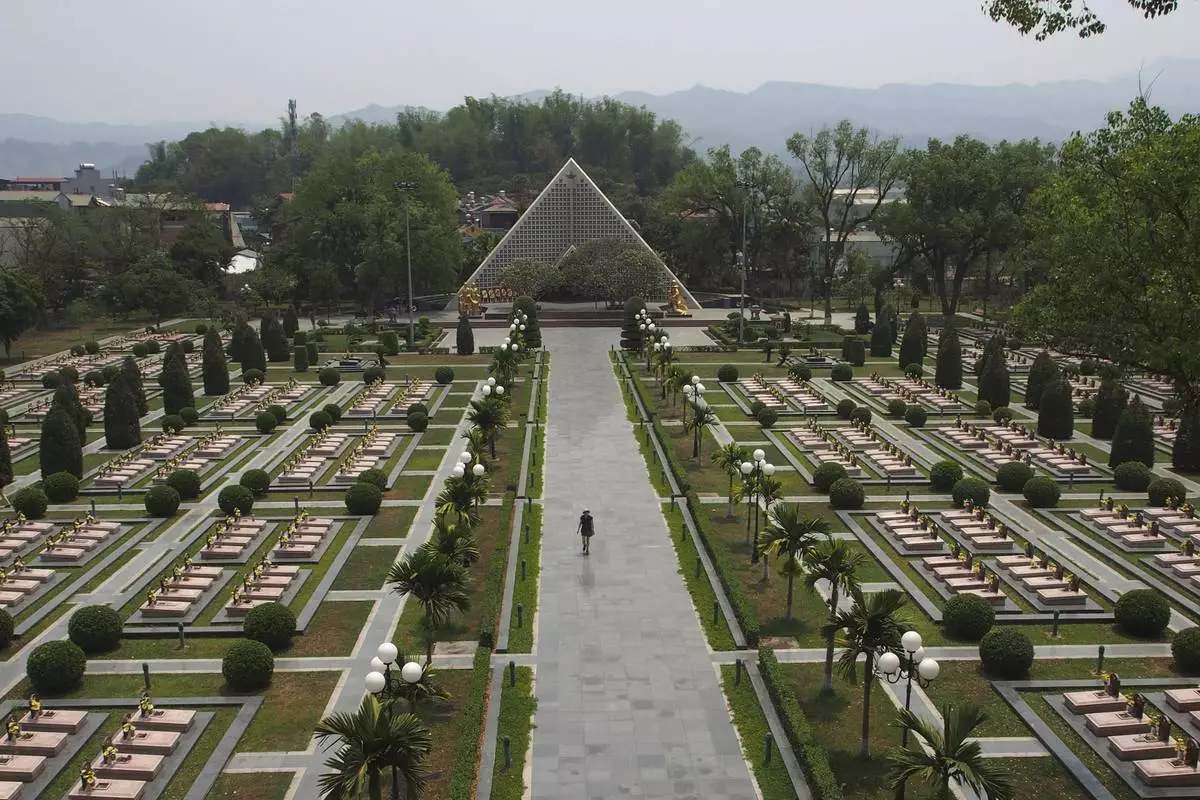 A tourist walks through the Dien Bien Phu Military Cemetery in Dien Bien Phu, Vietnam, April 22, 2019. (AP Photo/David Rising)