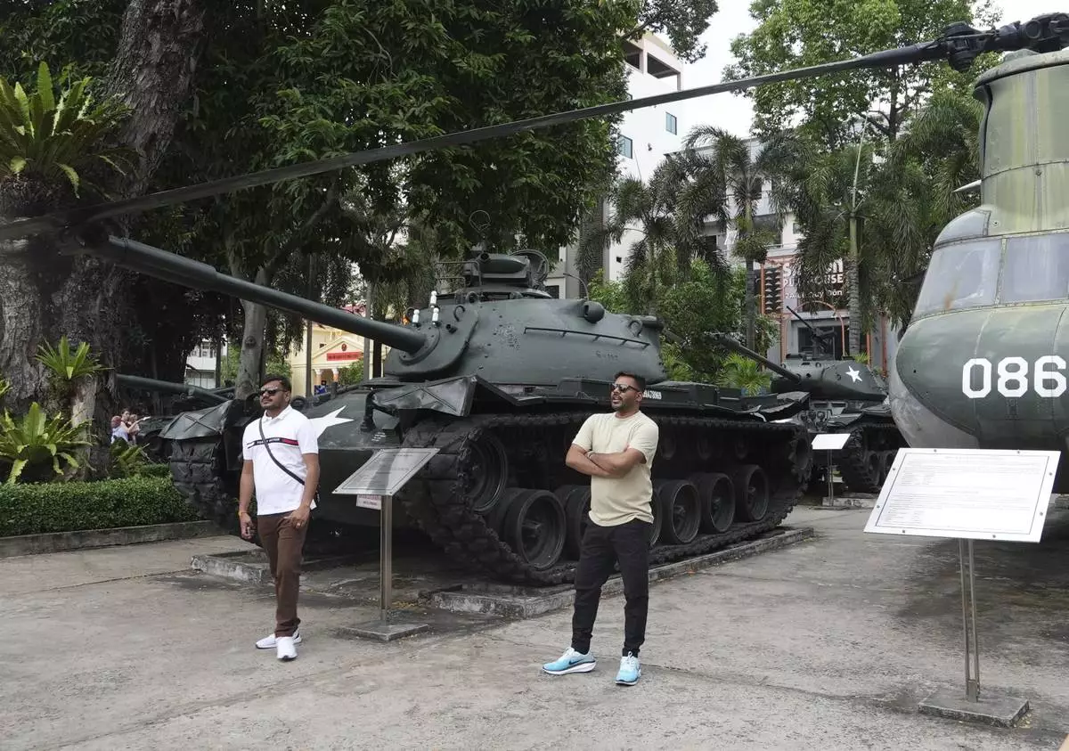 Tourists stand in front of armor combat vehicles on display at the War Remnants Museum in Ho Chi Minh City, Vietnam, Feb. 22, 2025. (AP Photo/Hau Dinh)
