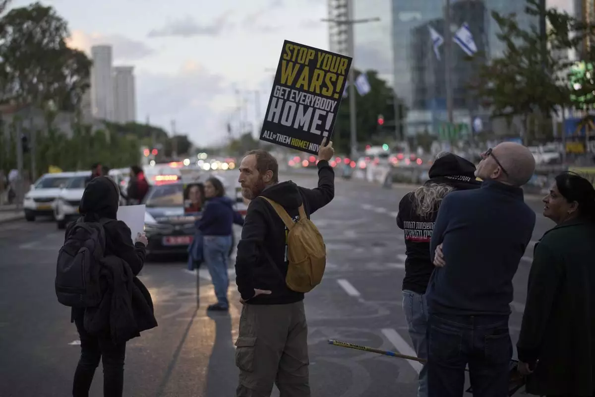 People gather in a protest demanding the immediate release of hostages held by Hamas in the Gaza Strip, during the Jewish holiday of Passover, in Tel Aviv, Israel, Saturday, April 12, 2025. (AP Photo/Leo Correa)
