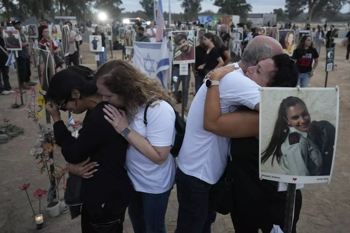 FILE - People visit the site of the Nova music festival, where hundreds of revelers were killed and abducted by Hamas and taken into Gaza, on the one-year anniversary of the attack, near Kibbutz Reim, southern Israel, Oct. 7, 2024. (AP Photo/Ariel Schalit, File)