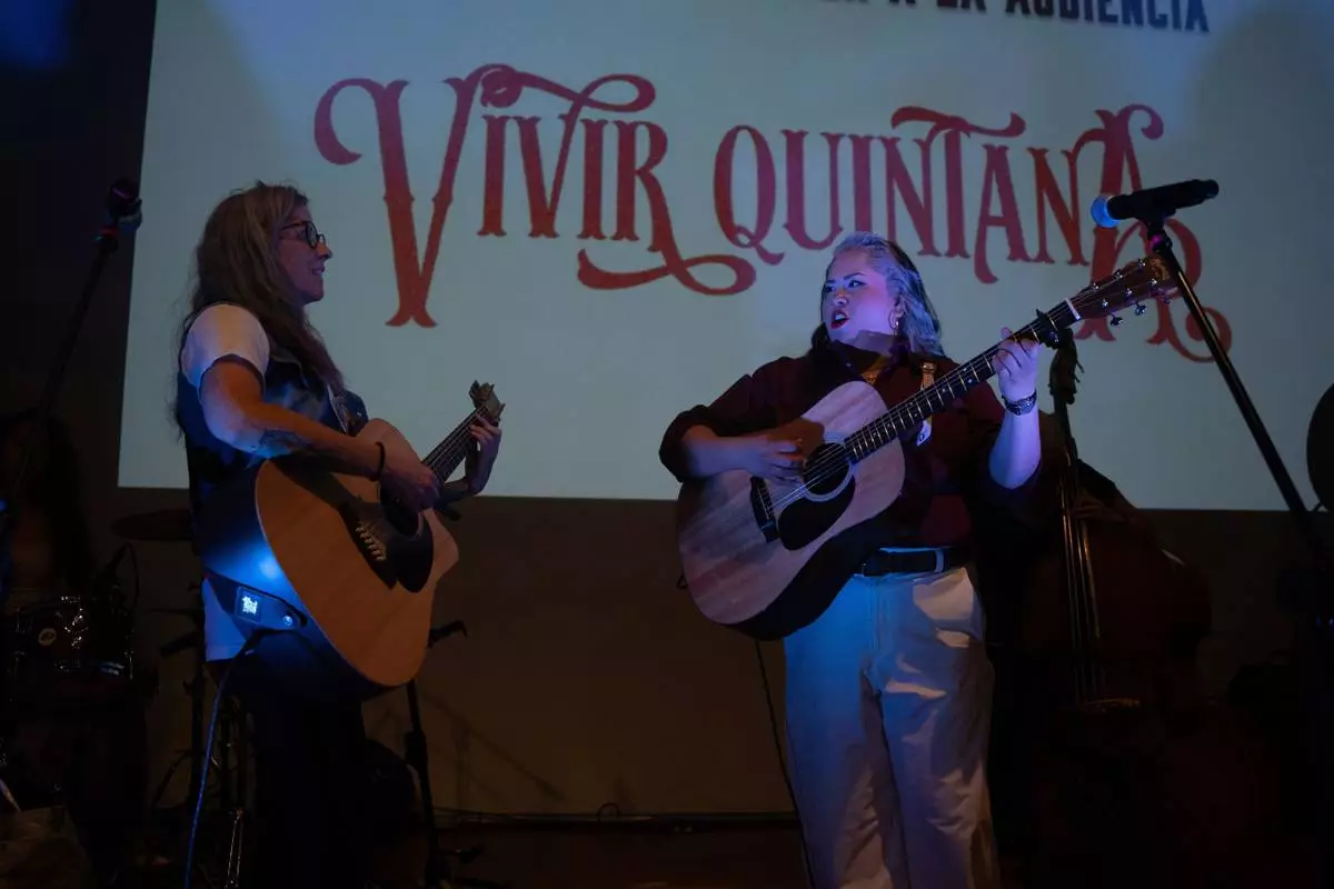 Mexican corridos singer Vivir Quintana, right, performs her new album, about violence against women, in Mexico City, Thursday, April 24, 2025. (AP Photo/Aurea Del Rosario)