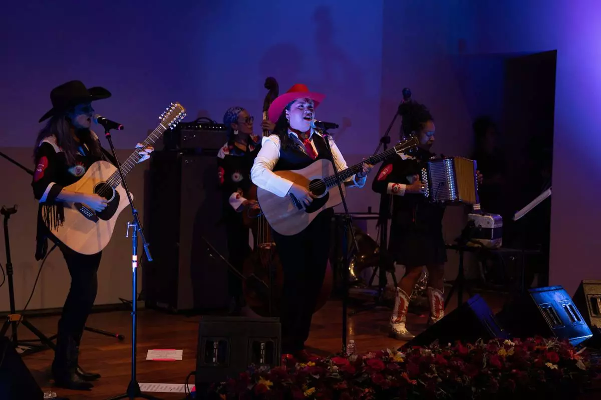 Mexican corridos singer Vivir Quintana, center, performs her new album, about violence against women, in Mexico City, Thursday, April 24, 2025. (AP Photo/Aurea Del Rosario)