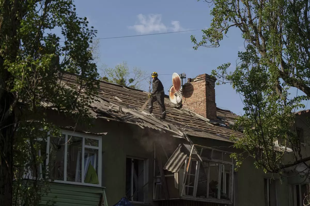 A rescue worker clears the rubble of a house damaged by a Russian strike on a residential neighbourhood in Kyiv, Ukraine, on Thursday, April 24, 2025. (AP Photo/Evgeniy Maloletka)