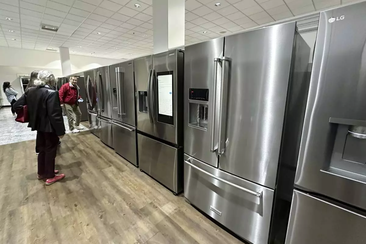 Customers shop refrigerators at a retail store in Glenview, Ill., Thursday, April 3, 2025. (AP Photo/Nam Y. Huh)