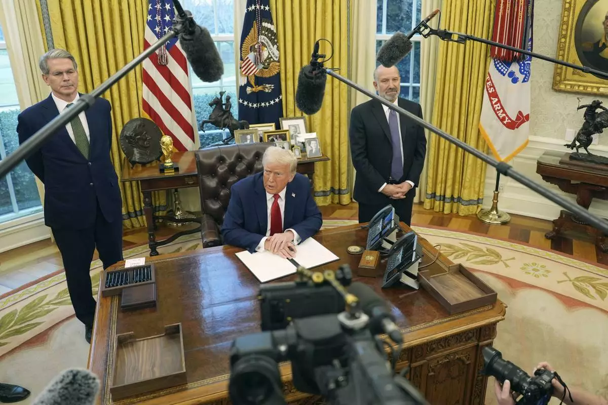 President Donald Trump speaks as Treasury Secretary Scott Bessent, left, and Commerce Secretary nominee Howard Lutnick listen as Trump prepares to sign an executive order in the Oval Office of the White House, Monday, Feb. 3, 2025, in Washington. (AP Photo/Evan Vucci)