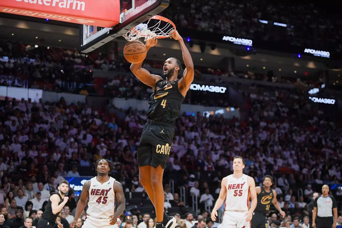 Cleveland Cavaliers forward Evan Mobley (4) scores against the Miami Heat during the second half in Game 3 of an NBA basketball first-round playoff series, Saturday, April 26, 2025, in Miami. (AP Photo/Michael Laughlin)