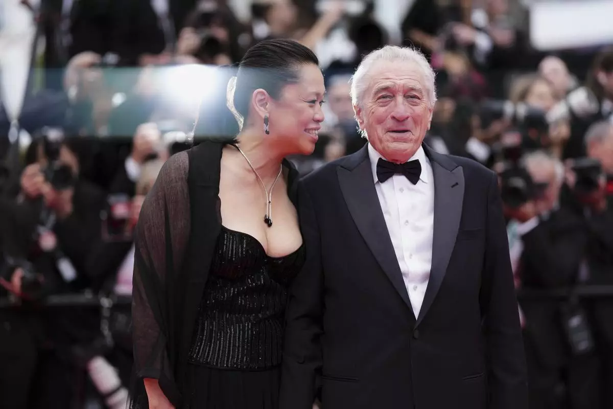 Tiffany Chen, left, and Robert De Niro pose for photographers during the opening ceremony red carpet of the 78th international film festival, Cannes, southern France, Tuesday, May 13, 2025. (Photo by Scott A Garfitt/Invision/AP)