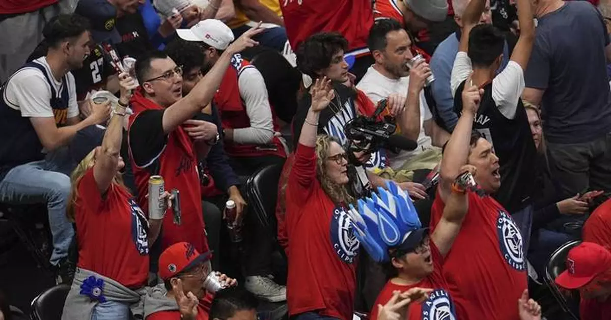 Wall of support: Clippers fans flown out to Denver by owner Steve Ballmer for Game 7 against Nuggets