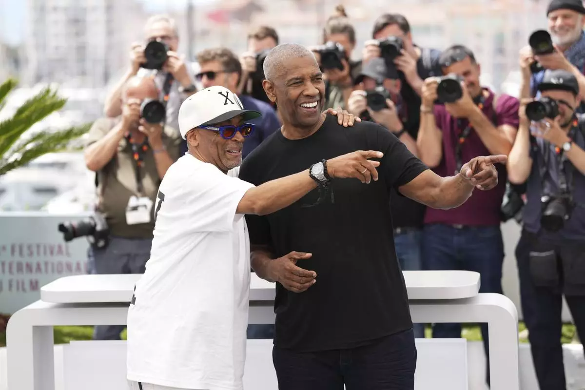 Director Spike Lee, left, and Denzel Washington pose for photographers at the photo call for the film 'Highest 2 Lowest' at the 78th international film festival, Cannes, southern France, Monday, May 19, 2025. (Photo by Scott A Garfitt/Invision/AP)