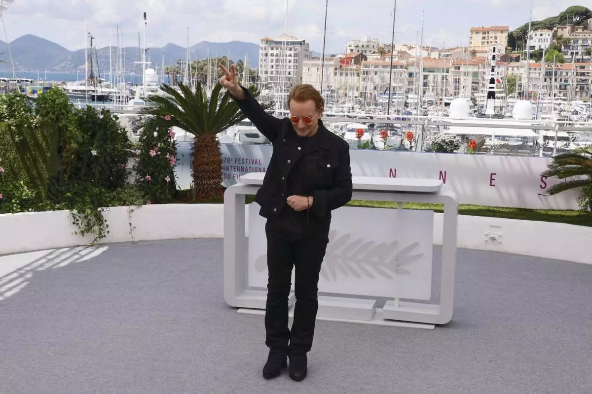 Bono poses for photographers at the photo call for the film 'Bono: Stories of Surrender' at the 78th international film festival, Cannes, southern France, Saturday, May 17, 2025. (Photo by Joel C Ryan/Invision/AP)