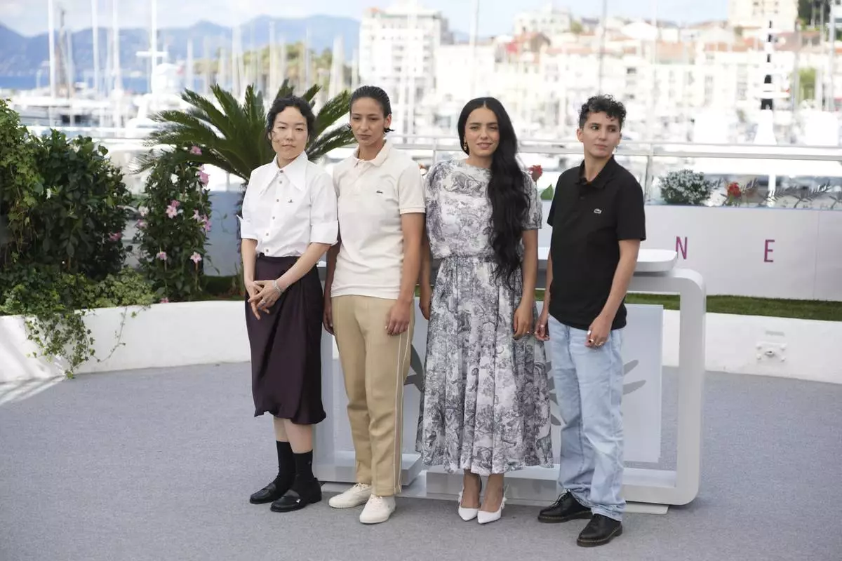 Park Ji-min, from left, Nadia Melliti, director Hafsia Herzi and writer Fatima Daas pose for photographers at the photo call for the film 'La Petite Derniere' at the 78th international film festival, Cannes, southern France, Saturday, May 17, 2025. (AP Photo/Natacha Pisarenko)