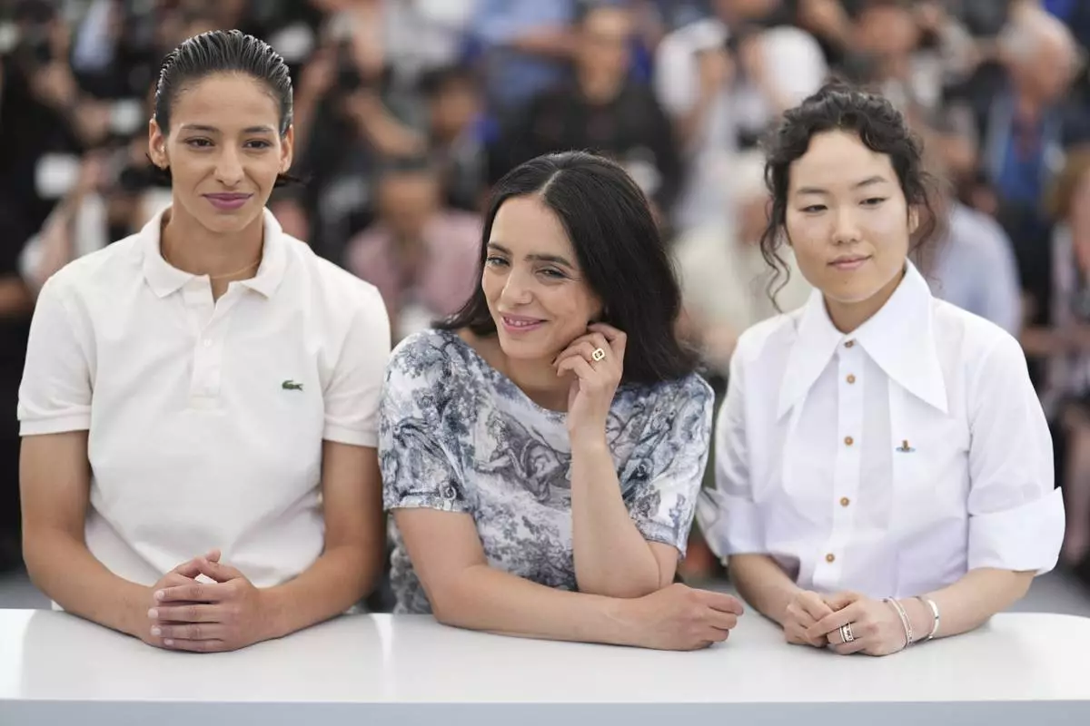 Nadia Melliti, from left, director Hafsia Herzi and Park Ji-min pose for photographers at the photo call for the film 'La Petite Derniere' at the 78th international film festival, Cannes, southern France, Saturday, May 17, 2025. (Photo by Lewis Joly/Invision/AP)