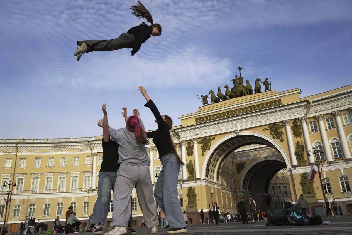 Youths practice their skills in cheerleading outside Palace Square in St. Petersburg, Russia, Tuesday, May 27, 2025. (AP Photo/Dmitri Lovetsky)