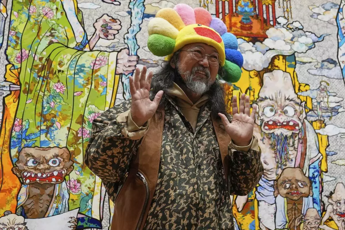 Takashi Murakami greets visitors to an exhibit of his art at the Cleveland Museum of Art in Cleveland, Thursday, May 15, 2025. (AP Photo/Sue Ogrocki)
