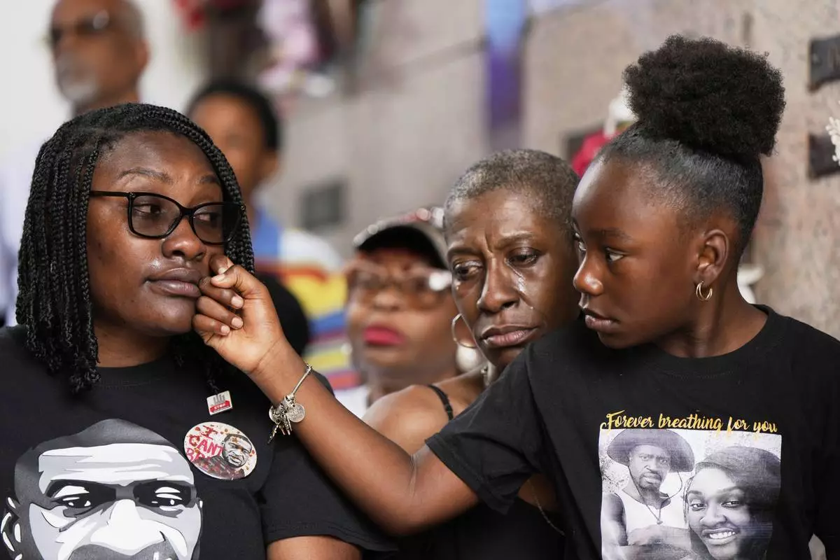 Family members of George Floyd, from left, Bianca Williams, Zsa Zsa Floyd, and Arianna Williams, 7, react during a memorial service on the anniversary of Floyd's death on Sunday, May 25, 2025, in Houston. (AP Photo/Ashley Landis)