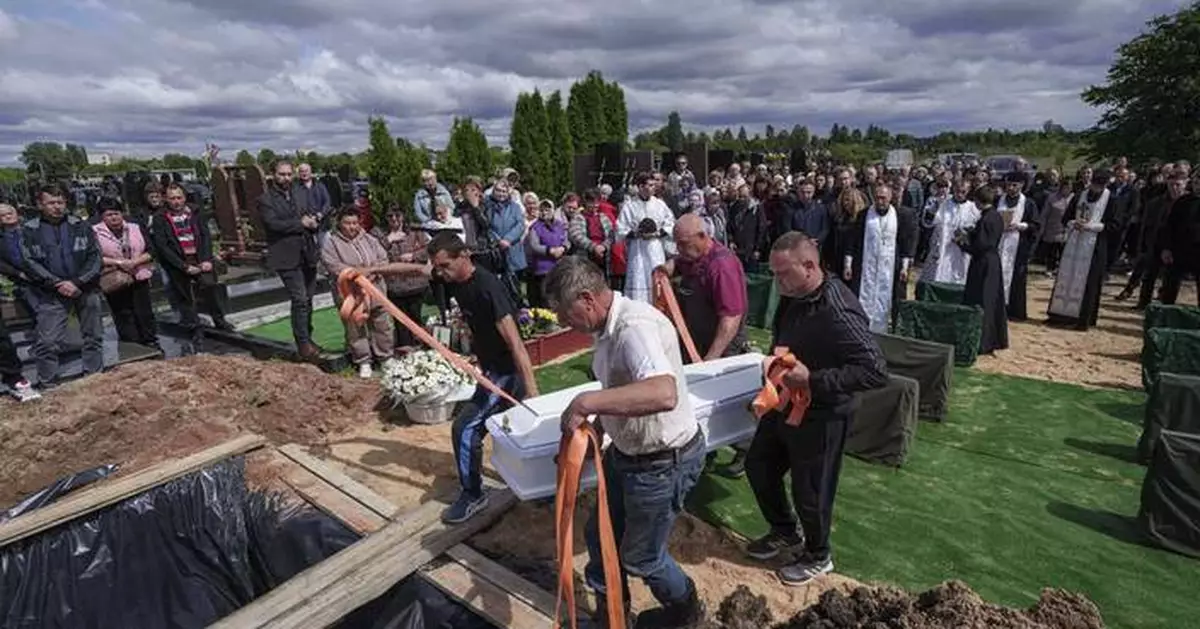 Funeral of 3 siblings killed in Russian strike underscores mounting toll on Ukrainian families