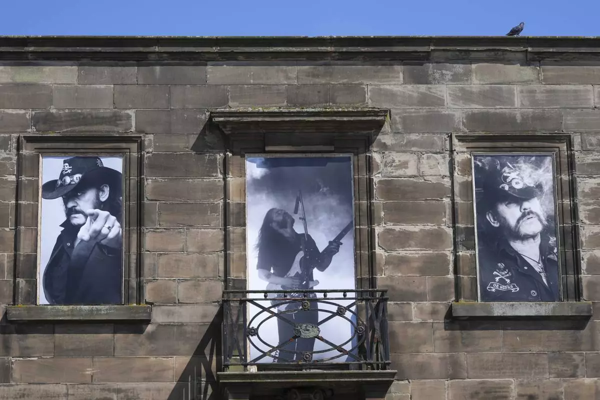 Windows of a house are covered with posters of singer Lemmy Kilmister to commemorate the Motorhead frontman in Burslem, Stoke on Trent, England, Friday, May 9, 2025. The musician, once described as having 'one of the most recognizable voices in rock', was born in Burslem and a statue has been crafted by acclaimed local sculptor and lifelong Motorhead fan Andy Edwards. (AP Photo/Kirsty Wigglesworth)