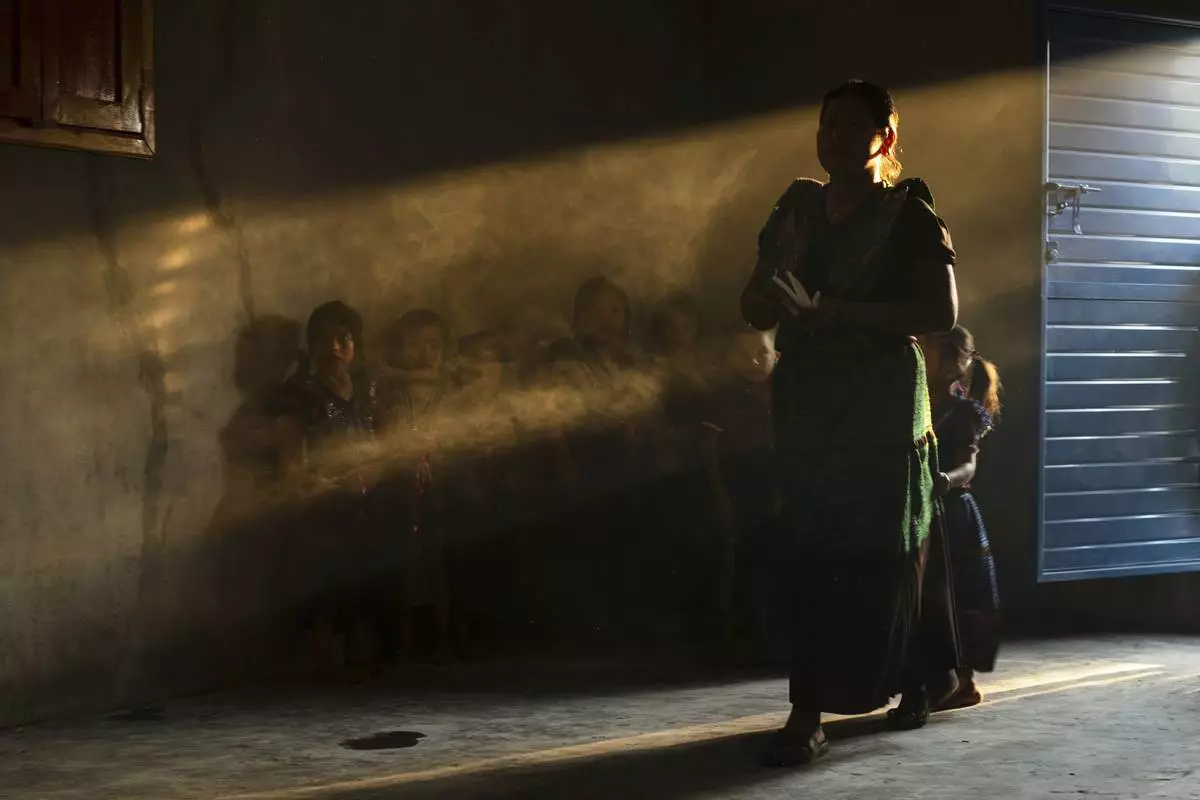 Congregants attend an Indigenous blessing ceremony for Communion wafers that will be taken to a priest to be consecrated before they can be given out, in the Simojovel municipality, Mexico, Saturday, April 26, 2025. (AP Photo/Isabel Mateos)