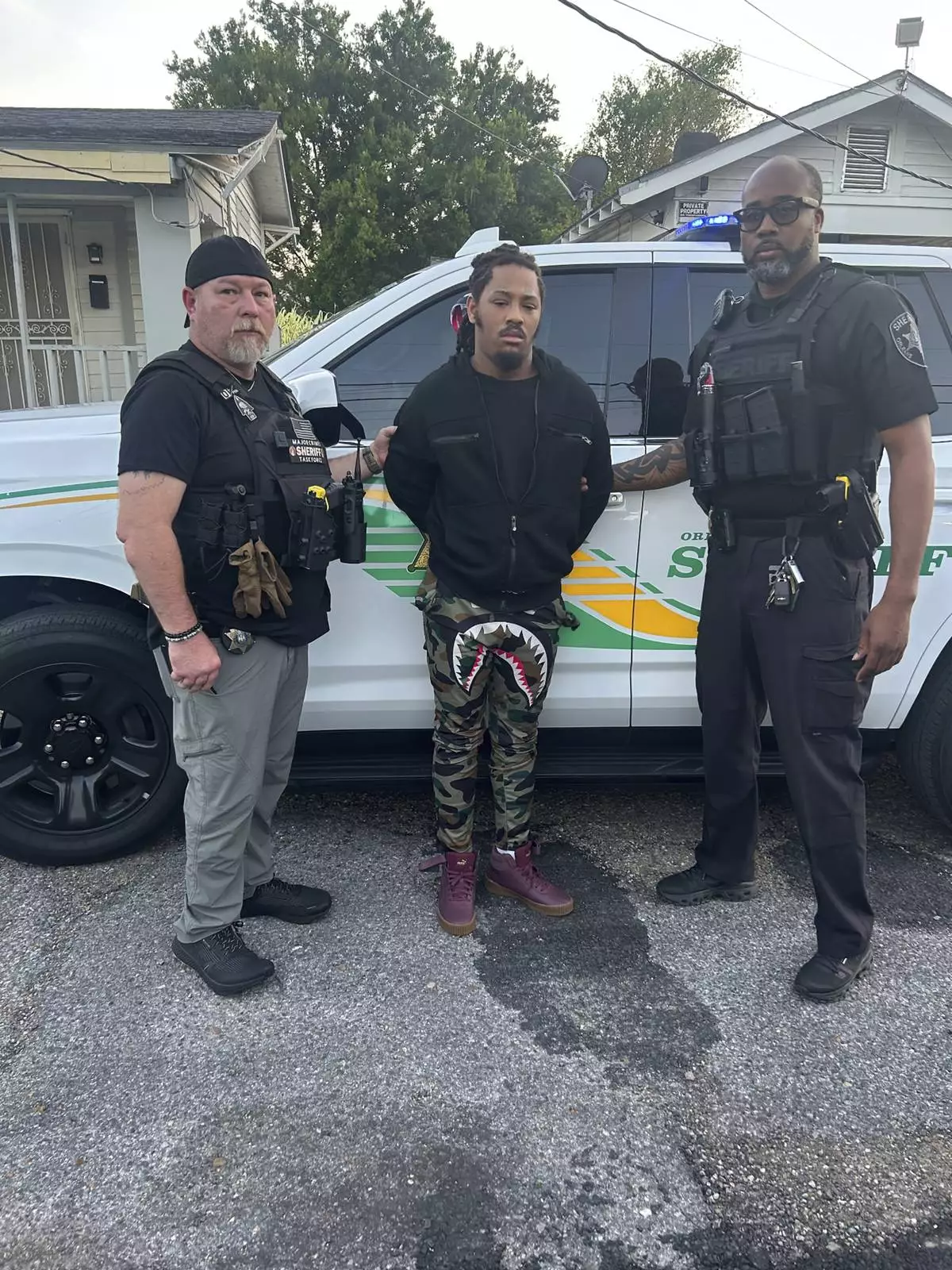 This photo provided by the Orleans Parish Sheriff's Office shows escaped inmate Robert Moody, center flanked by Detective Charles Morgan, left, and Detective Bryant Parish, right, after he had been captured in New Orleans on Friday May, 16, 2025. ( Orleans Parish Sheriff's Office via AP)