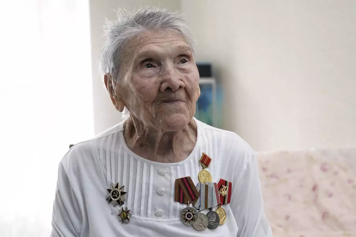 World War II veteran Olga Savenko, 101, poses for a portrait in Almaty, Kazakhstan, on Wednesday, April 16, 2025. Savenko joined the Soviet army on the front lines in 1941, when she was just 18, and served as a communications operator. (AP Photo/Vladimir Tretyakov)