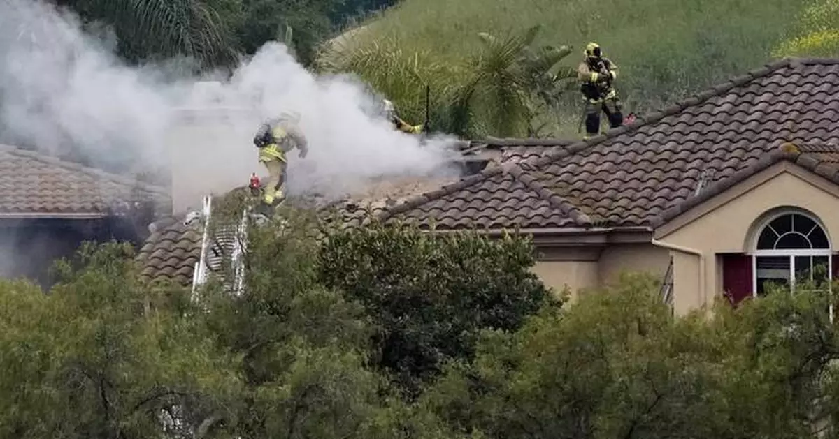 A small plane crashes into a Los Angeles-area neighborhood, killing 2 people and a dog