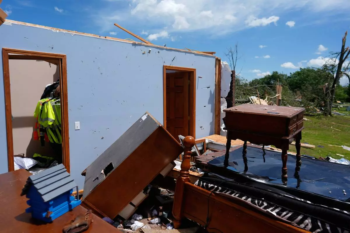 A home is destroyed after a severe storm passed the area on Saturday, May 17, 2025, in London, Ky. (AP Photo/Carolyn Kaster)