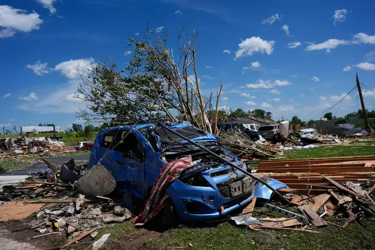A vehicle is covered in debris after a severe storm passed the area on Saturday, May 17, 2025,in London, Ky. (AP Photo/Carolyn Kaster)