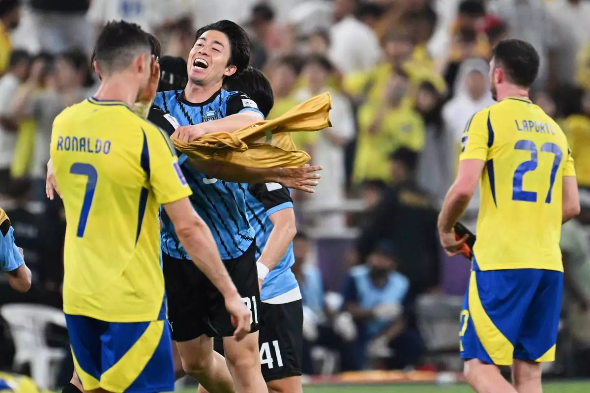 Kawasaki Frontale players, center, celebrate after defeating Al Nassr in a AFC Champions League Elite semifinal soccer match at Alinma Stadium in Jeddah, Saudi Arabia, Wednesday, April 30, 2025. (AP Photo/Ali Issa)