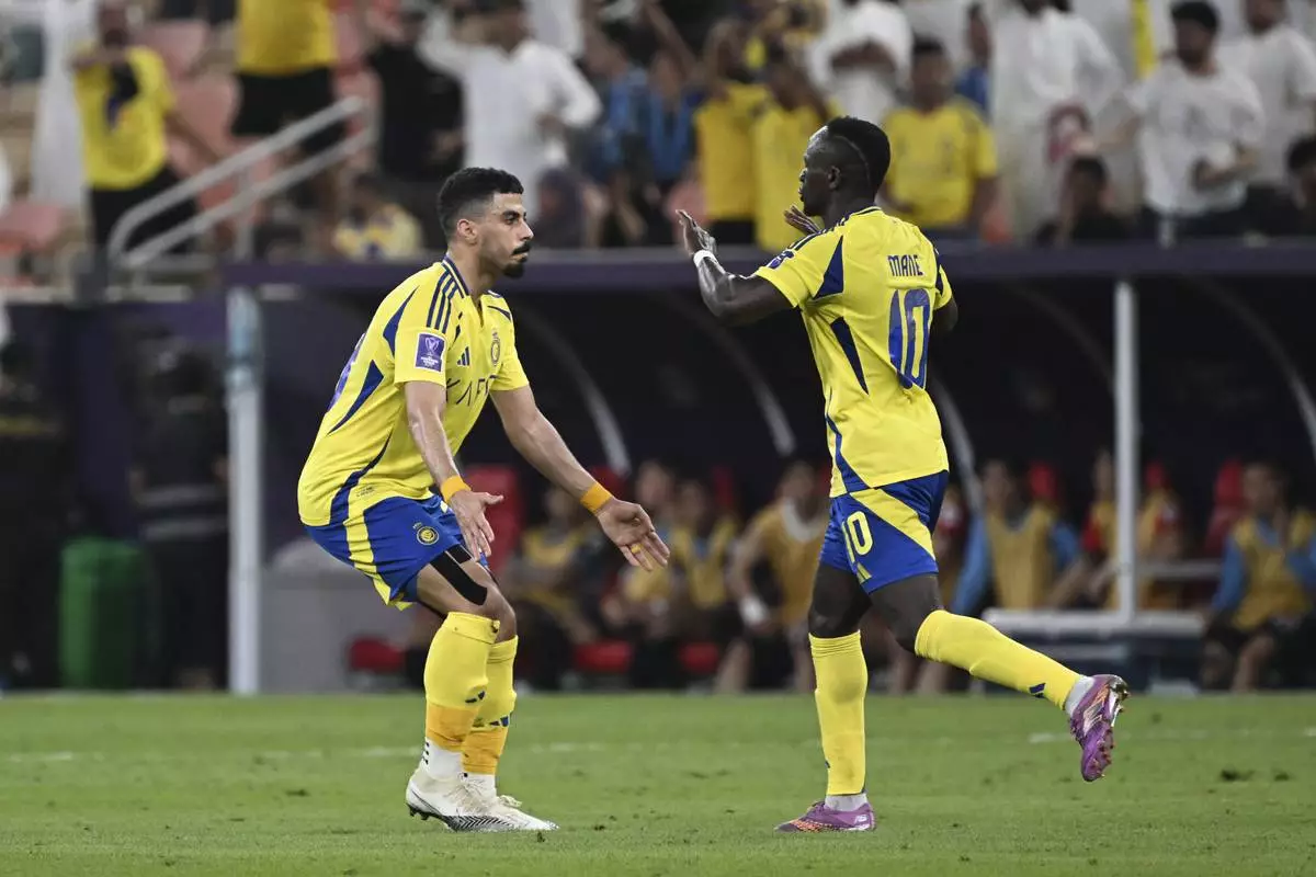 Al Nassr's Sadio Mane, right, celebrates after scoring against Japan's Kawasaki Frontale, during a AFC Champions League Elite semifinal soccer match at Alinma Stadium in Jeddah, Saudi Arabia, Wednesday, April 30, 2025. (AP Photo/Ali Issa)
