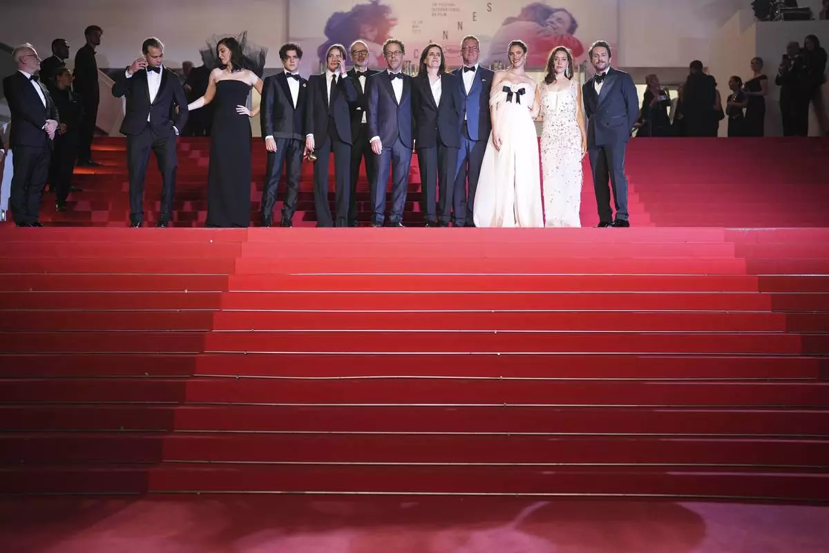 Josh Pafchek, from left, Lera Abova, Jacnier, Talia Ryder, Eric Fellner, director Ethan Coen, writer Tricia Cooke, producer Robert Graf, Margaret Qualley, Aubrey Plaza and Charlie Day pose for photographers upon arrival at the premiere of the film 'Honey Don't!' at the 78th international film festival, Cannes, southern France, Friday, May 23, 2025. (Photo by Scott A Garfitt/Invision/AP)