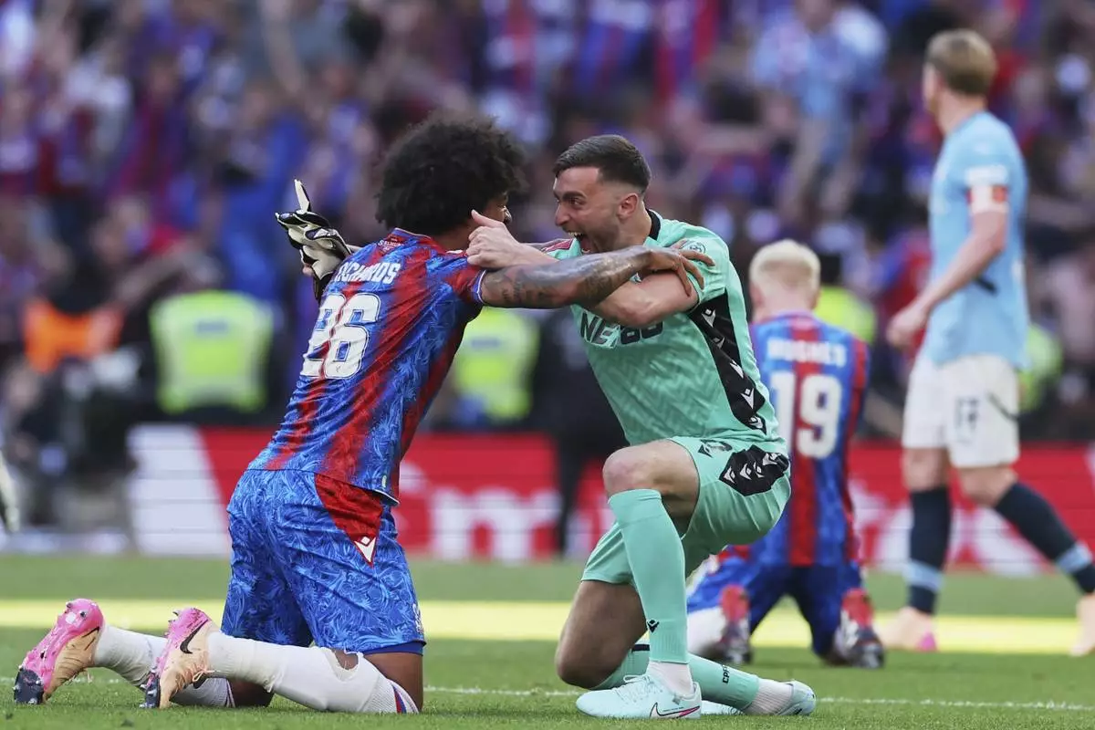 CORRECTS ID TO BACKUP GOALKEEPER MATT TURNER, NOT DEAN HENDERSON - Crystal Palace's Chris Richards and backup goalkeeper Matt Turner celebrate after winning the FA Cup final between Manchester City and Crystal Palace at the Wembley Stadium in London, Saturday, May 17, 2025. (AP Photo/Ian Walton)