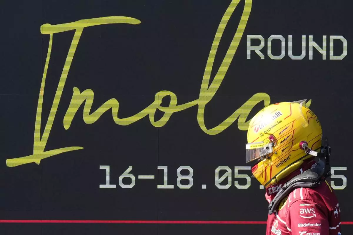 Ferrari driver Lewis Hamilton of Britain walks through parc ferme after the Italian Emilia Romagna Formula One Grand Prix, at the Enzo and Dino Ferrari racetrack in Imola, Italy, Sunday, May 18, 2025. (AP Photo/Luca Bruno)