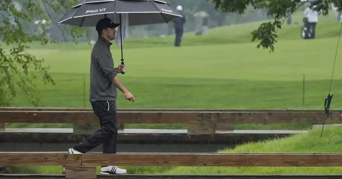 Nick Taylor makes it look easy in the rain and shares the lead at Memorial