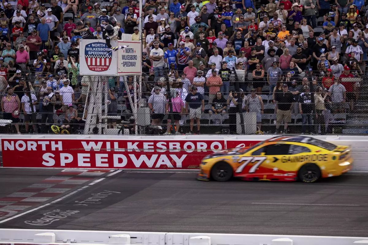 Carson Hocevar gets the checkered flag in the NASCAR All-Star Open auto race Sunday, May 18, 2025, in North Wilkesboro, N.C. (AP Photo/Scott Kinser)