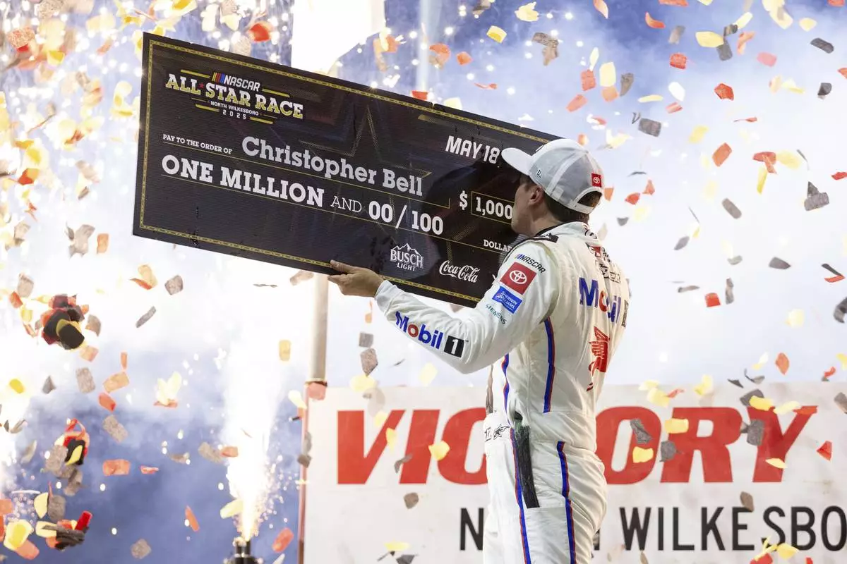 Christopher Bell celebrates after winning the NASCAR All-Star auto race Sunday, May 18, 2025, in North Wilkesboro, N.C. (AP Photo/Scott Kinser)