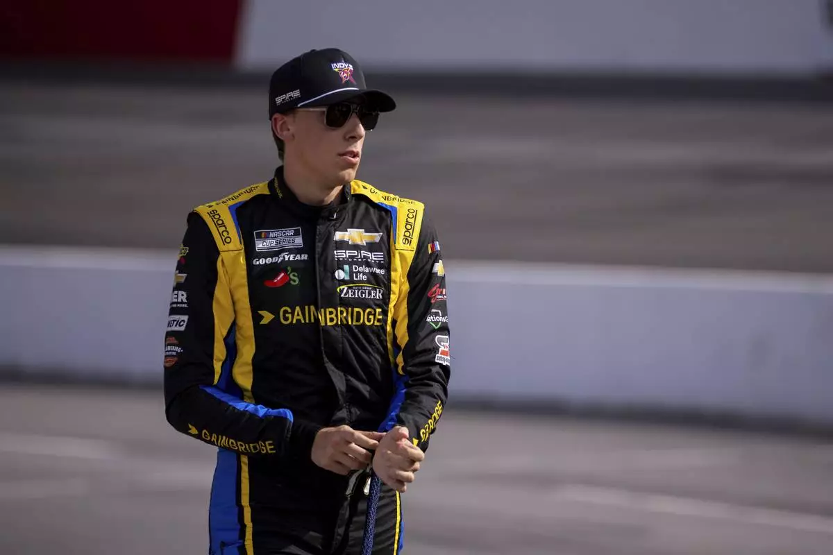 Carson Hocevar walks out to his car before the NASCAR All-Star Open auto race Sunday, May 18, 2025, in North Wilkesboro, N.C. (AP Photo/Scott Kinser)