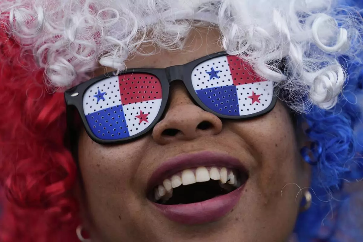 A woman protests the Panamanian government's decision to sign an agreement with the United States that demonstrators deem at odds with their sovereignty, in Panama City, Tuesday, April 29, 2025. (AP Photo/Matias Delacroix)