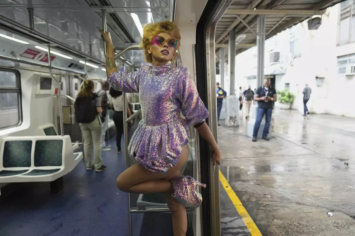 A member of the LGBTI community models a creation inspired by Lady Gaga's style, some made by the models themselves and others created by the sustainable fashion house "Escola de Divines," at the Central Train Station days before Lady Gaga's concert in Rio de Janeiro, Tuesday, April 29, 2025. (AP Photo/Silvia Izquierdo)
