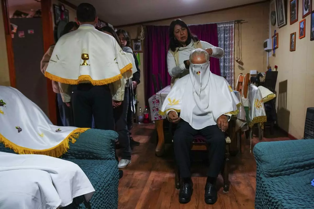 Fidel Guajardo, a horseback rider known as a huaso, preps with his daughter Soledad for the Quasimodo Feast, a procession held on the first Sunday after Easter, in Colina, Chile, April 27, 2025, on which the huasos accompany priests to give communion to the sick. (AP Photo/Esteban Felix)