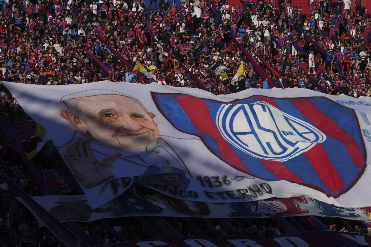 A San Lorenzo banner featuring the late Pope Francis is displayed in the stands, commemorating Francis who was a lifelong supporter of the club, during a local soccer match against Rosario Central in Buenos Aires, Argentina, Saturday, April 26, 2025. (AP Photo/Gustavo Garello)