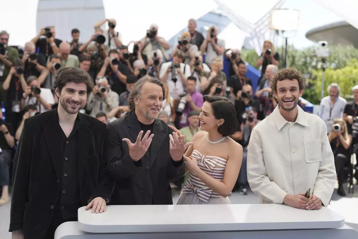 Guillaume Marbeck, from left, director Richard Linklater, Zoey Deutch and Aubry Dullin pose for photographers at the photo call for the film 'Nouvelle Vague' at the 78th international film festival, Cannes, southern France, Sunday, May 18, 2025. (AP Photo/Natacha Pisarenko)