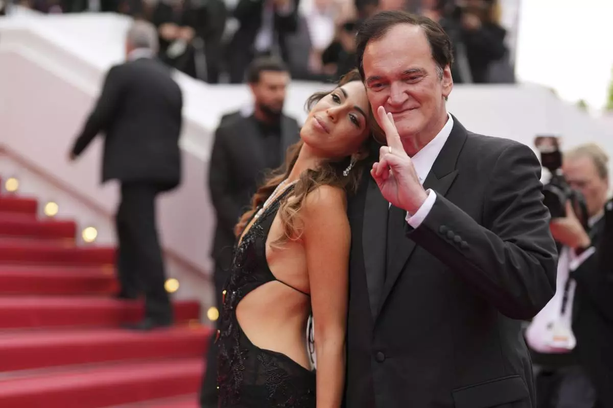 Daniella Pick, left, and Quentin Tarantino pose for photographers upon arrival at the premiere of the film 'Nouvelle Vague' at the 78th international film festival, Cannes, southern France, Saturday, May 17, 2025. (AP Photo/Natacha Pisarenko)