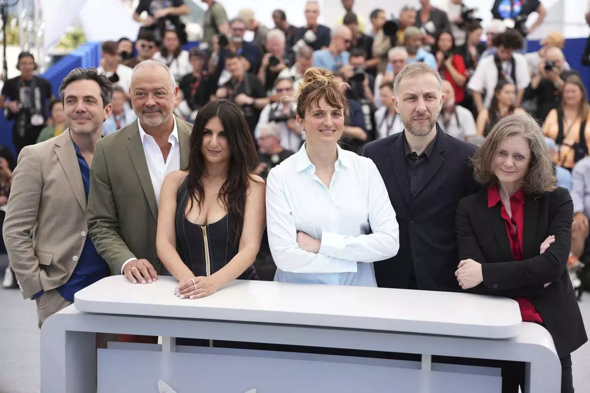 Jury president Alice Rohrwacher, second from left, and jury members Frederic Mercier, Tommaso Vergallo, Geraldine Nakache, Rachid Hami, and Pascale Marin pose for photographers at the photo call for the Camera d'Or jury at the 78th international film festival, Cannes, southern France, Wednesday, May 14, 2025. (Photo by Scott A Garfitt/Invision/AP)