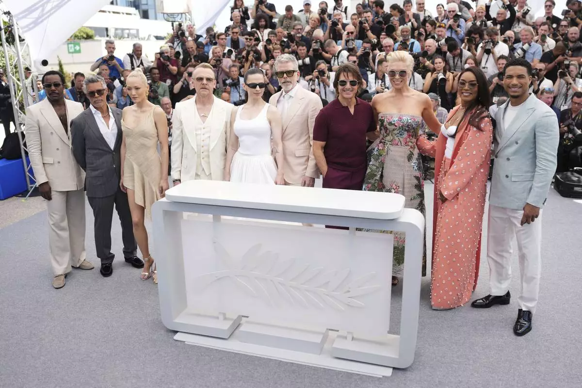 Tramell Tillman, from left, Esai Morales, Pom Klementieff, Simon Pegg, Hayley Atwell, director Christopher McQuarrie, Tom Cruise, Hannah Waddingham, Angela Bassett and Greg Tarzan Davis pose for photographers during the photo call for the film 'Mission: Impossible – The Final Reckoning' at the 78th international film festival, Cannes, southern France, Wednesday, May 14, 2025. (Photo by Scott A Garfitt/Invision/AP)